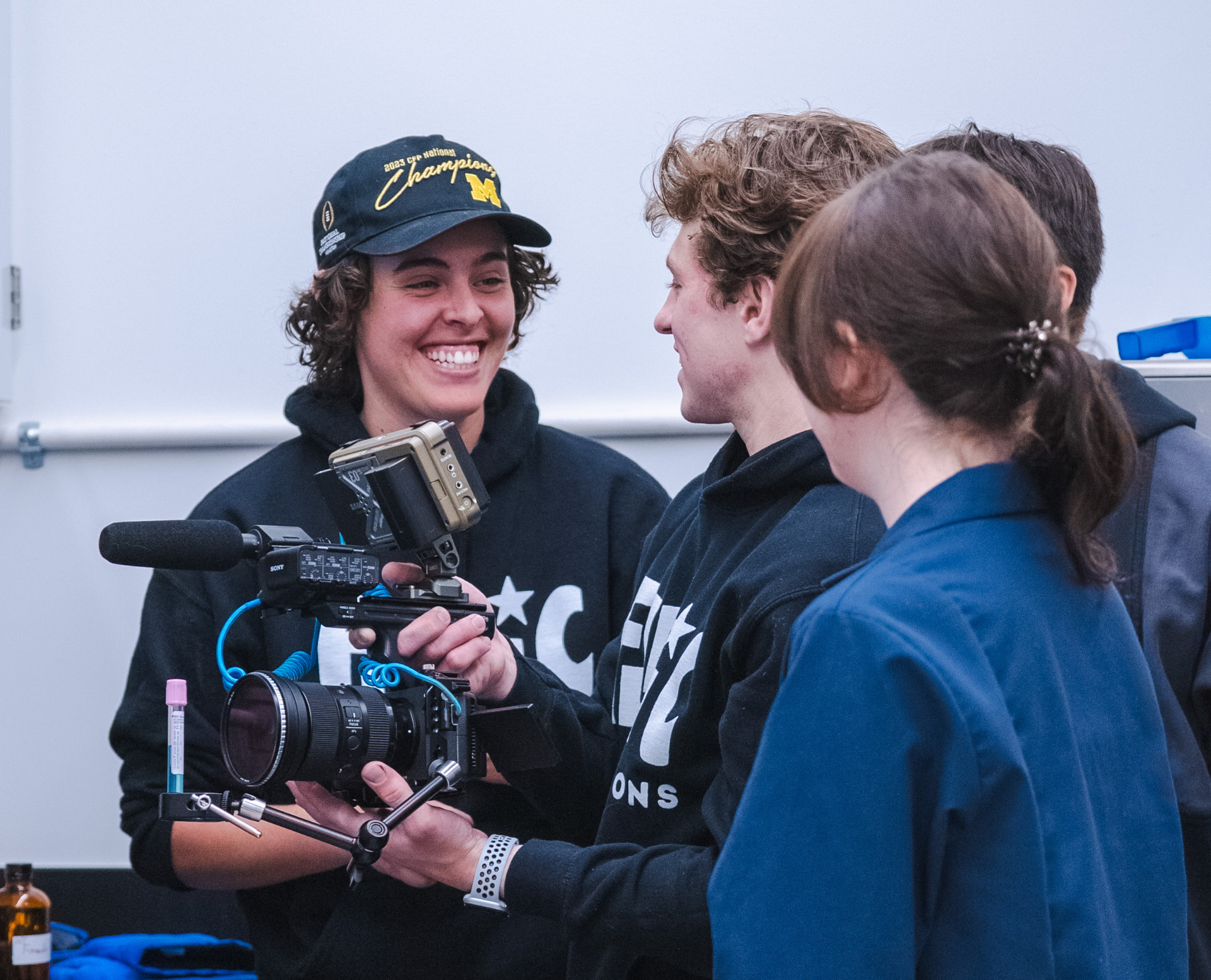 Maddie smiling with a camera crew on set